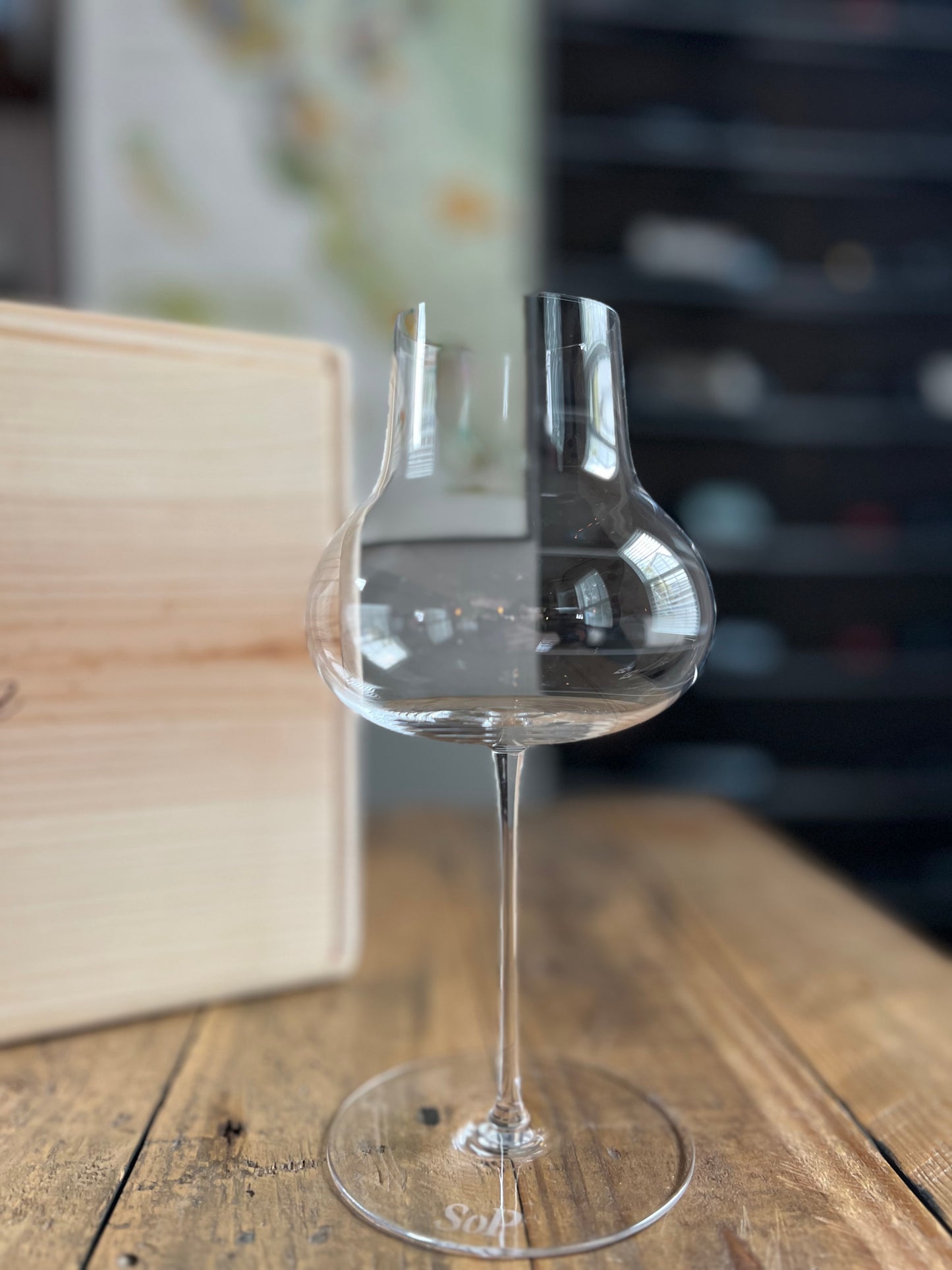 A featherlight, hand-blown lead-free crystal, wine glass like a Zalto, Reidel, Glasvin, Grassl, or Gabriel Glas with napa valley wine in the background for wine tasting.